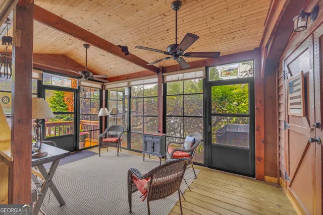 a living room with furniture and a floor to ceiling window
