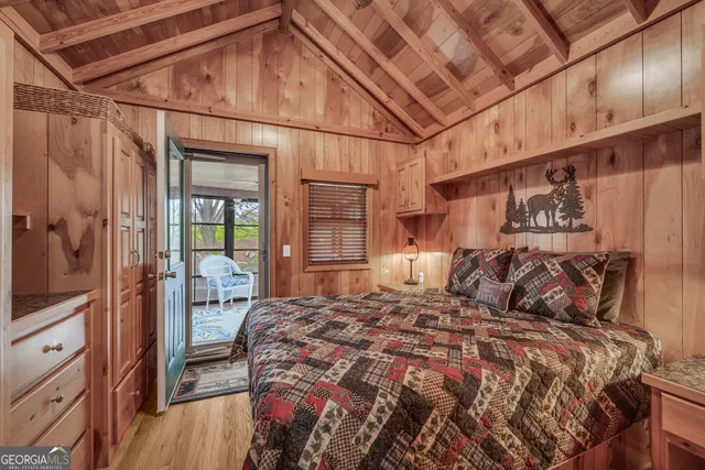 a bedroom with furniture and large windows