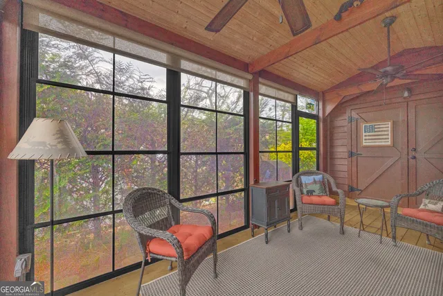 a outdoor living space with furniture and a flat screen tv