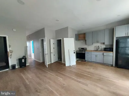 a kitchen with a white cabinets and a refrigerator