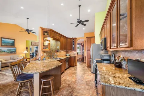 a large kitchen with lots of counter space and windows