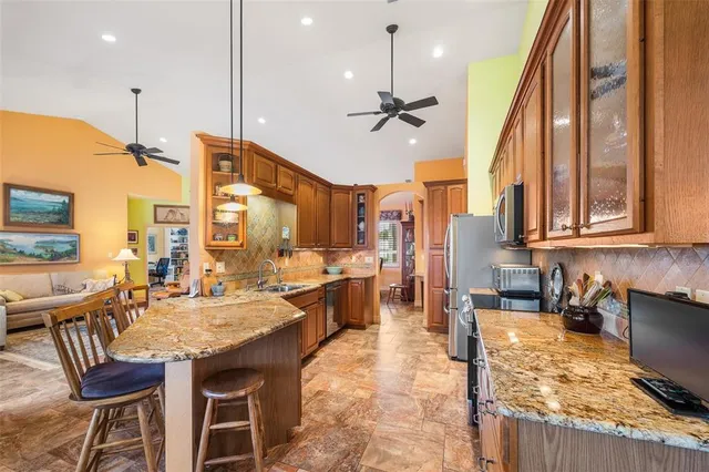 a large kitchen with lots of counter space and windows