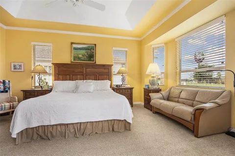 a bedroom with a bed couch and window