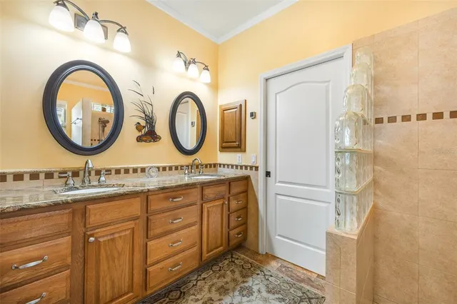 a bathroom with a large mirror vanity and a shower
