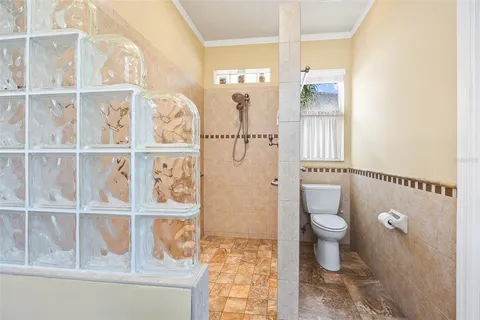 a bathroom with a toilet and a shower