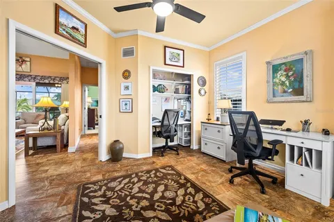 a view of a livingroom with workspace and a window