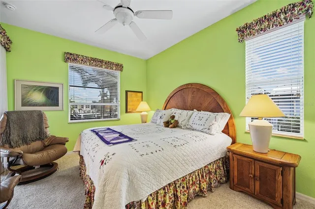 a bedroom with a bed a couch and a window