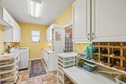 a room with furniture a rug and white walls