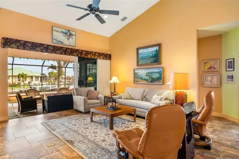 a living room with furniture fireplace and a large window
