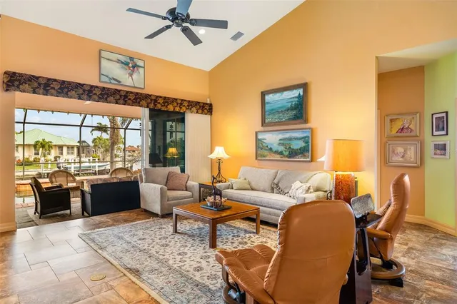 a living room with furniture fireplace and a large window