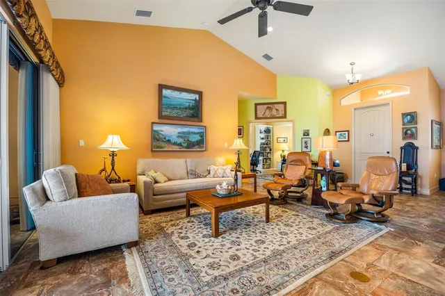 a living room with furniture wooden floor and a table