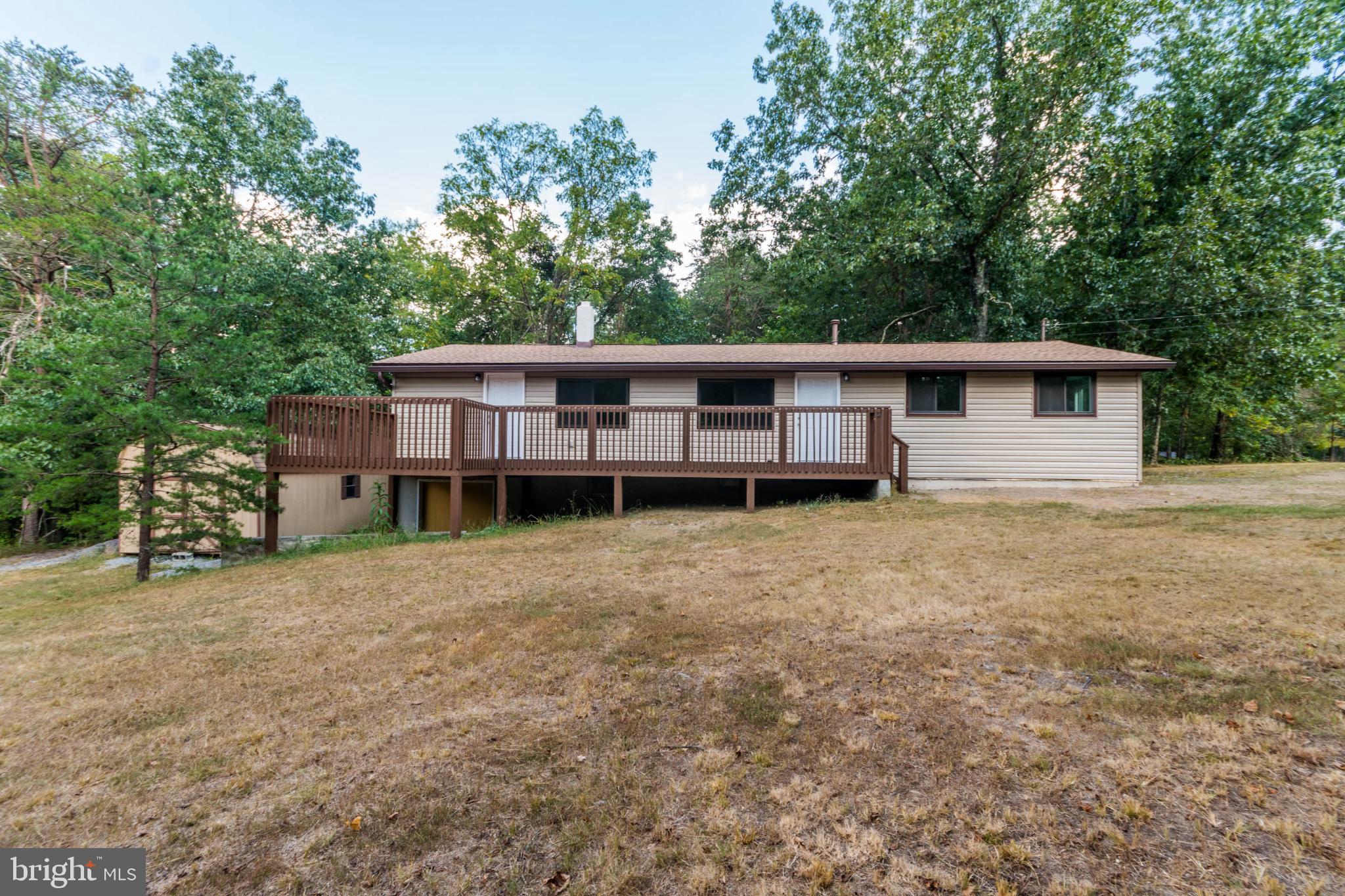 a view of a house with backyard and porch