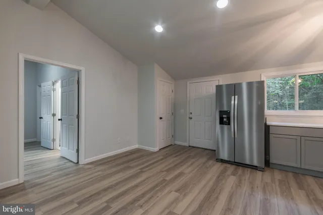 a view of a house with a yard and large trees