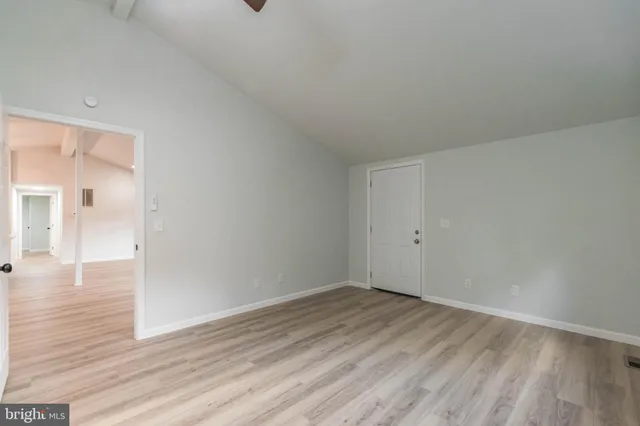 an aerial view of a house with a yard and large tree