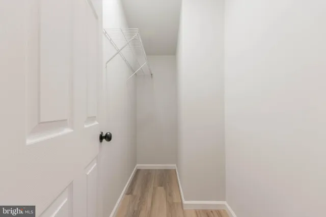 a front view of a house with a yard and large trees