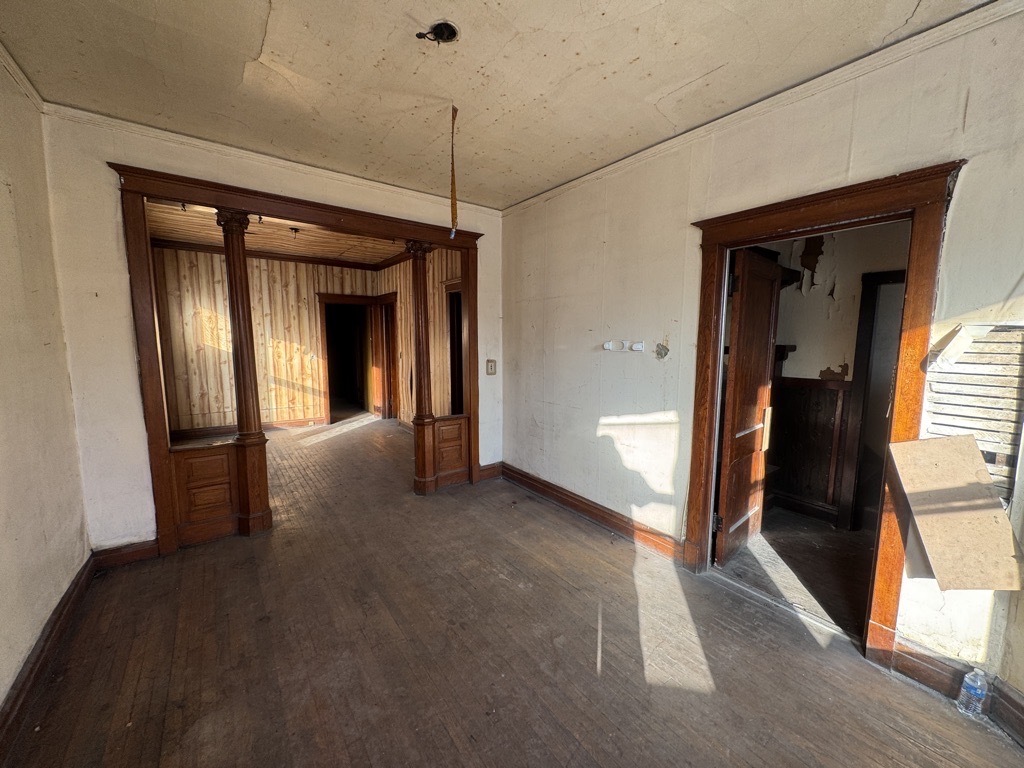 6744 South Bishop Street Chicago, IL 60636 - Photo 12 of 13 a view of a hallway with wooden floor and stairs