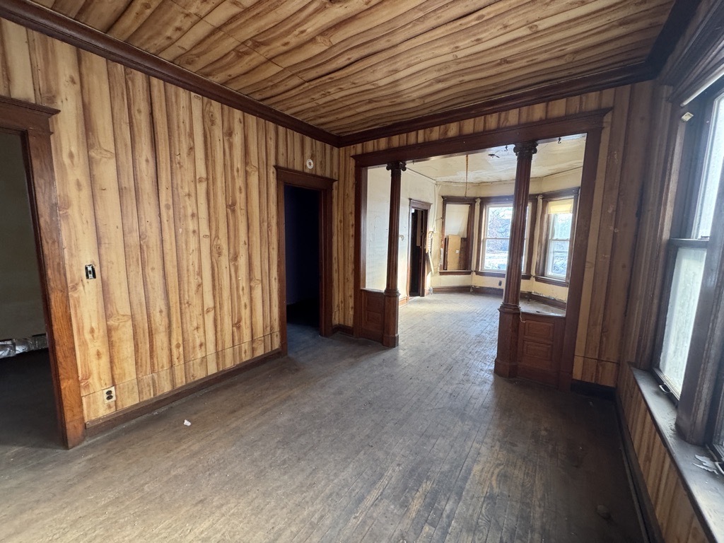 6744 South Bishop Street Chicago, IL 60636 - Photo 6 of 13 a view of a hallway to an empty room with wooden floor and a window