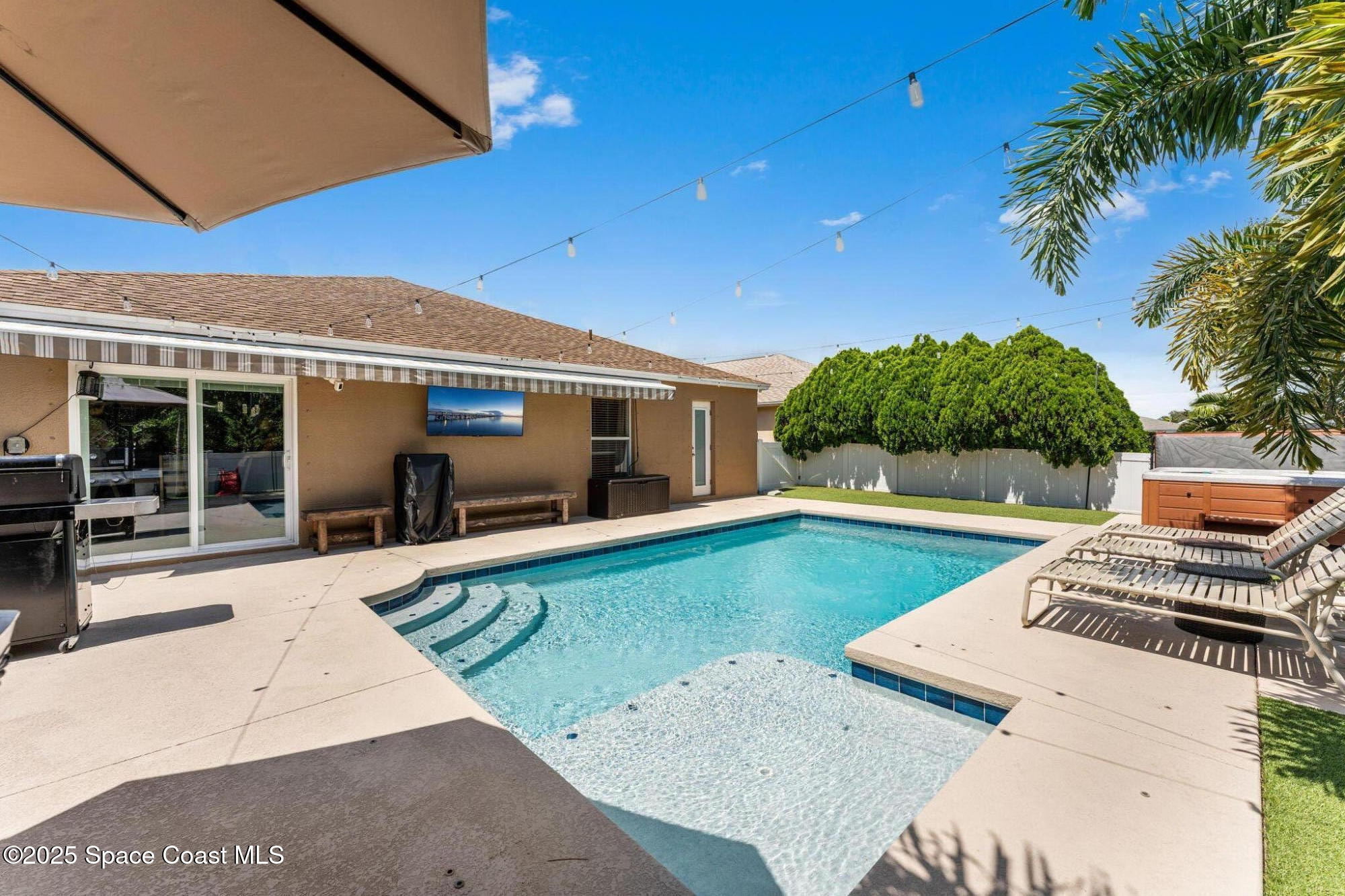 a view of a backyard with swimming pool