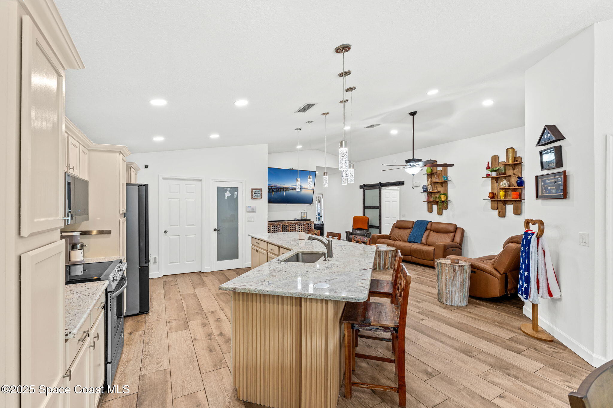 1292 Brumpton Place Rockledge, FL 32955 - Photo 11 of 69 a kitchen with stainless steel appliances kitchen island granite countertop a refrigerator and a stove top oven