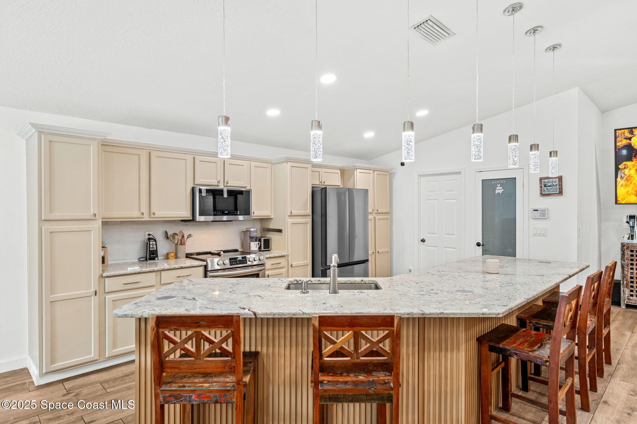 1292 Brumpton Place Rockledge, FL 32955 - Photo 12 of 69 a kitchen with stainless steel appliances granite countertop a kitchen island a stove a refrigerator a sink and a island