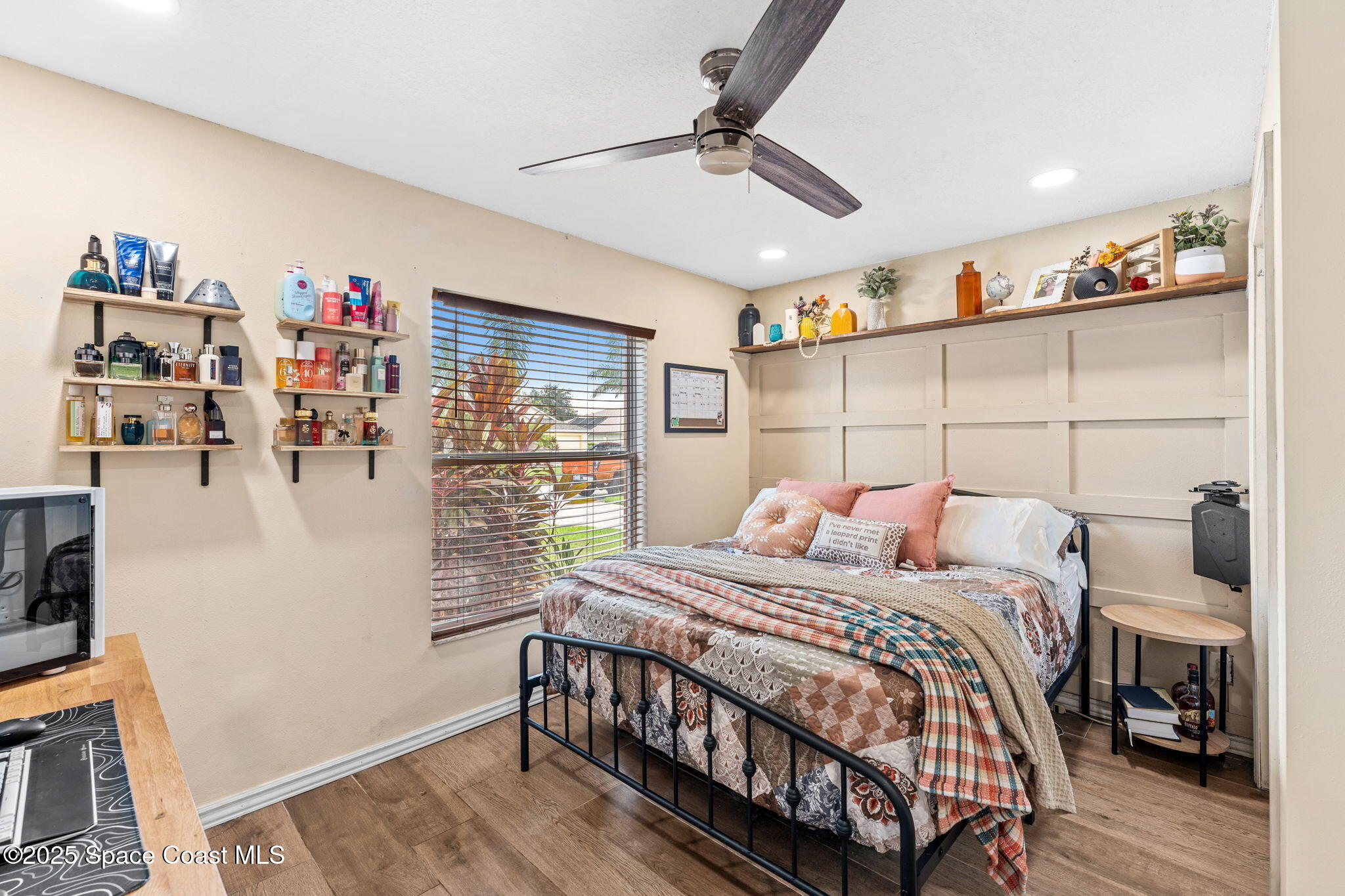1292 Brumpton Place Rockledge, FL 32955 - Photo 16 of 69 a bedroom with a bed a window and book shelf