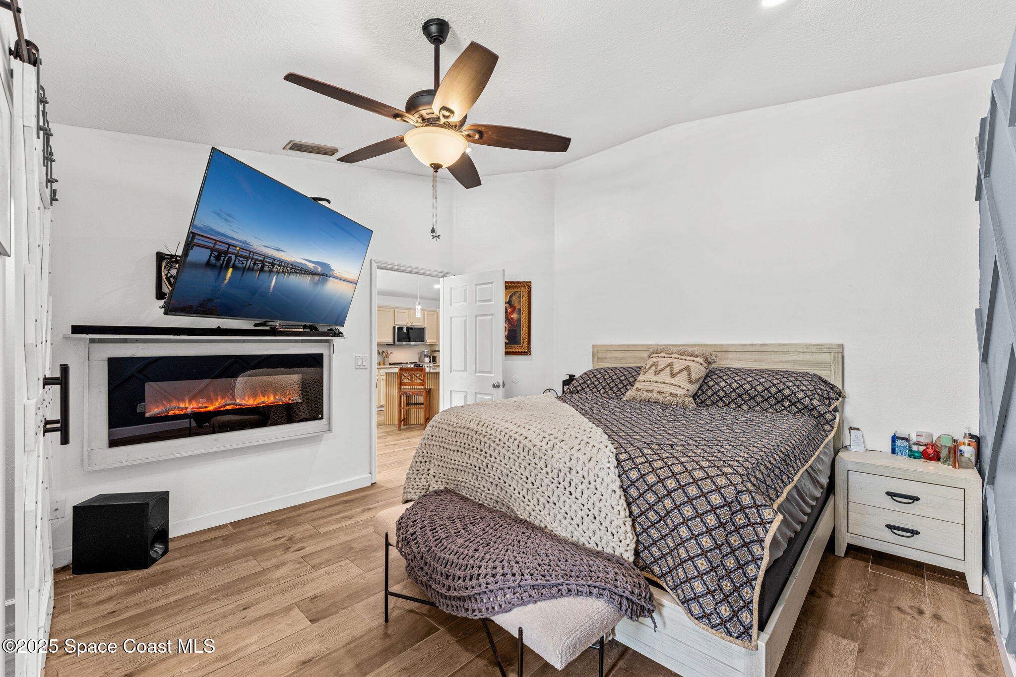 1292 Brumpton Place Rockledge, FL 32955 - Photo 19 of 69 a bedroom with a bed ceiling fan and a fireplace