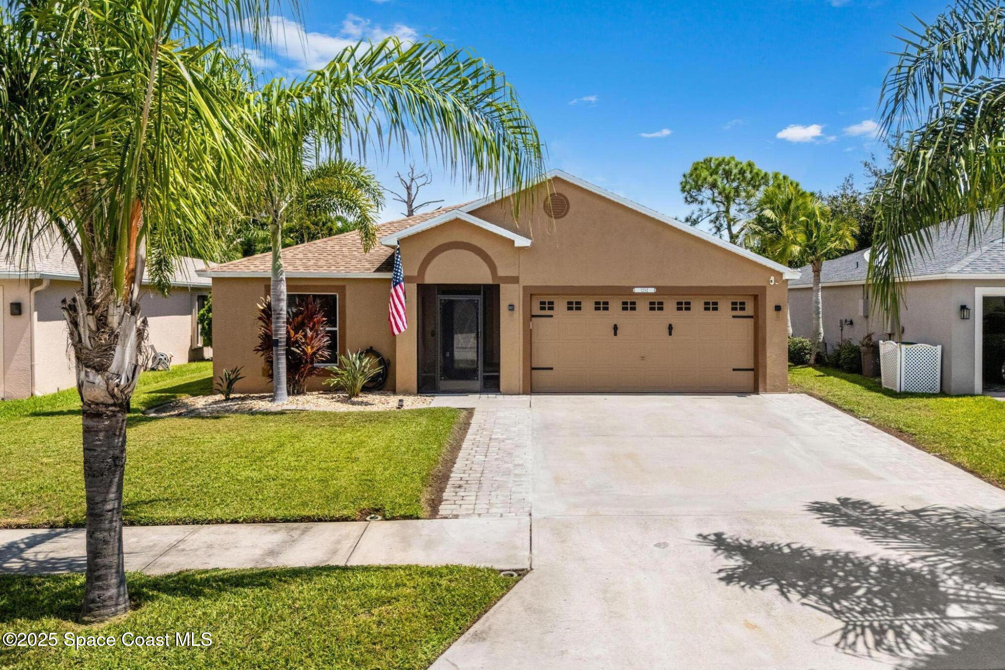 1292 Brumpton Place Rockledge, FL 32955 - Photo 2 of 69 a front view of a house with garden