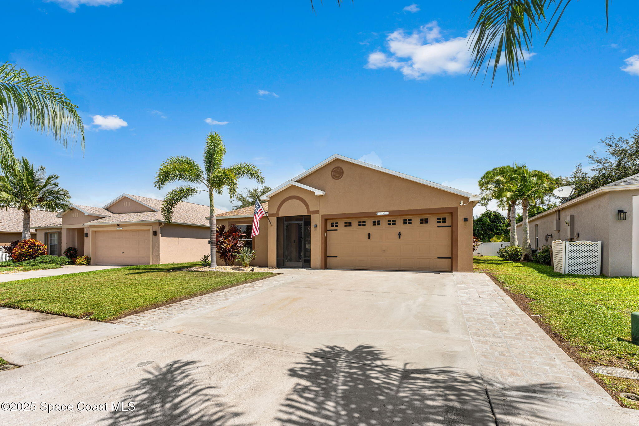 1292 Brumpton Place Rockledge, FL 32955 - Photo 42 of 69 a front view of a house with a yard and palm trees