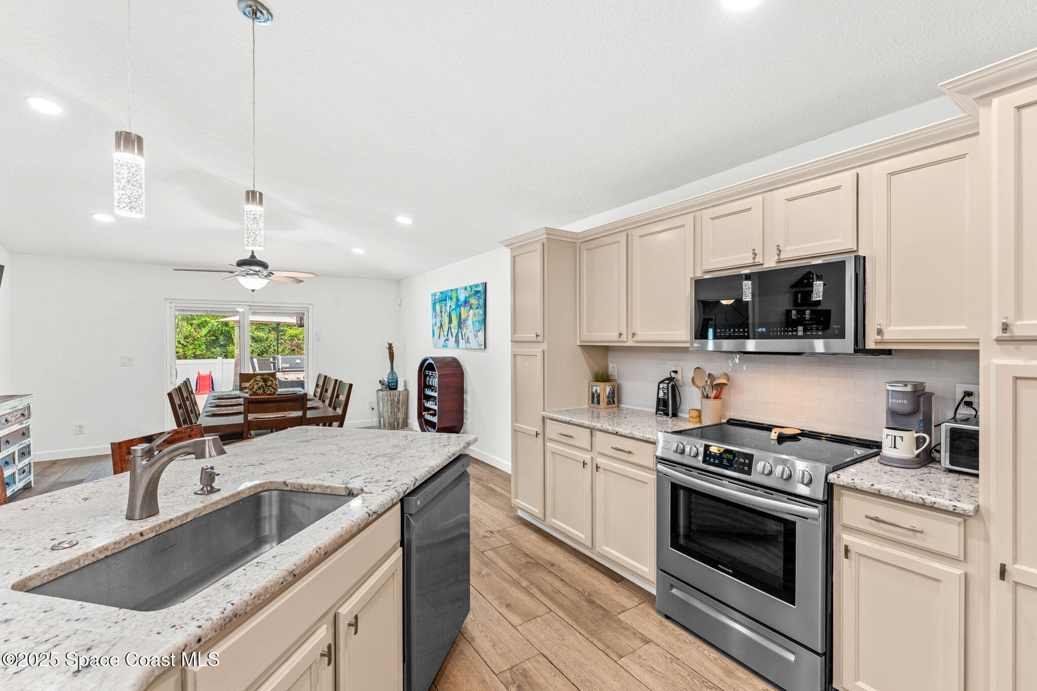 1292 Brumpton Place Rockledge, FL 32955 - Photo 8 of 69 a kitchen with stainless steel appliances granite countertop a sink stove and microwave