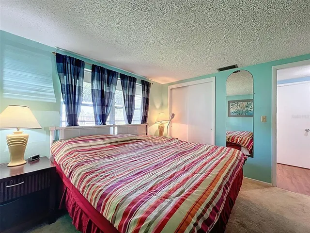 a bedroom with bed and window