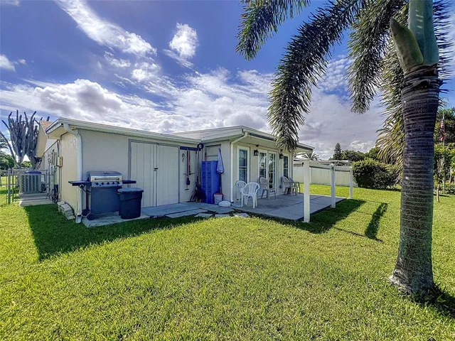 a view of an house with backyard space and swimming pool