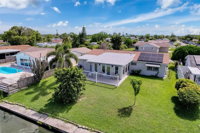 an aerial view of a house with swimming pool garden and patio