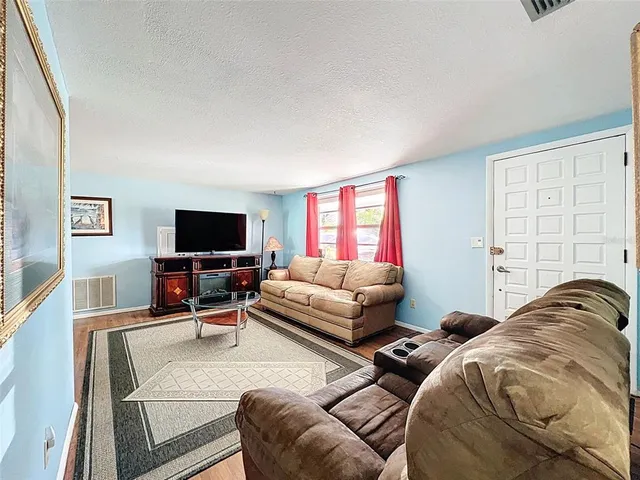 a bedroom with furniture and a flat screen tv