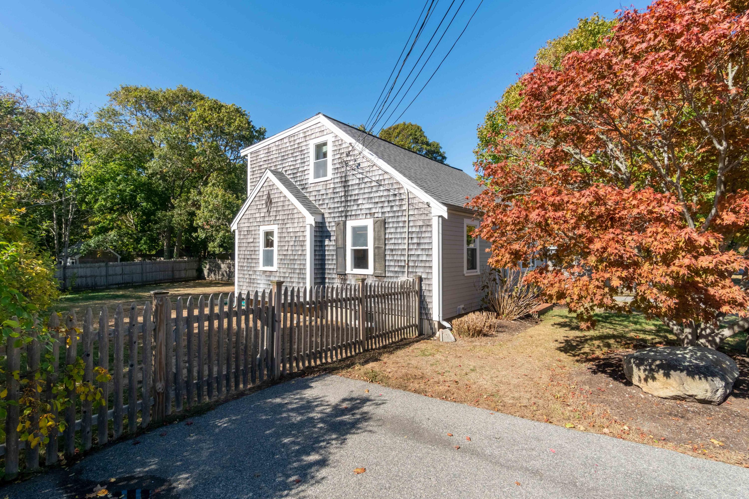 85 Old Town Road Hyannis, MA 02601 - Photo 24 of 26 a view of a white house with wooden fence and floor
