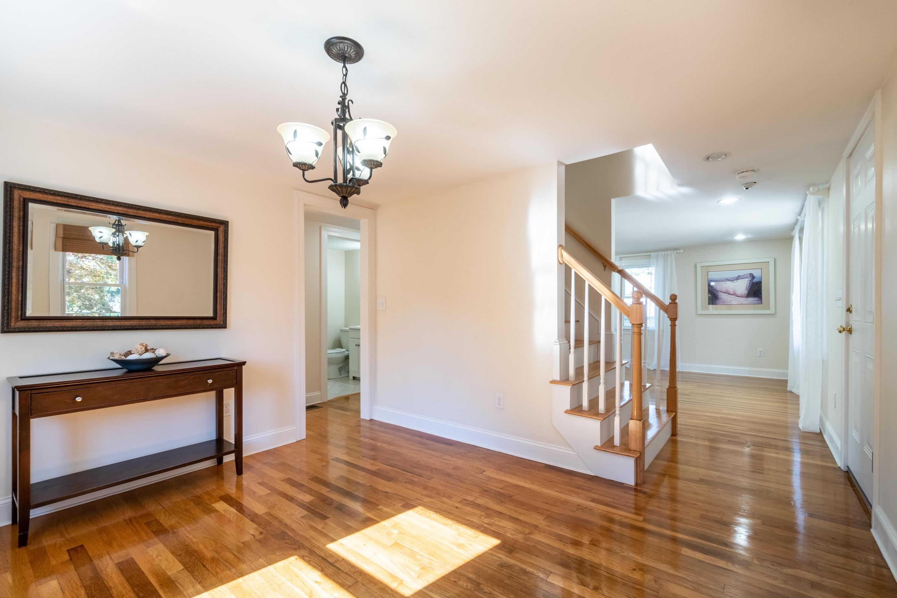 85 Old Town Road Hyannis, MA 02601 - Photo 10 of 26 a view of a livingroom with wooden floor and a chandelier