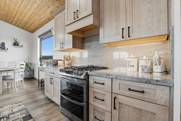 a kitchen with granite countertop stainless steel appliances and cabinets
