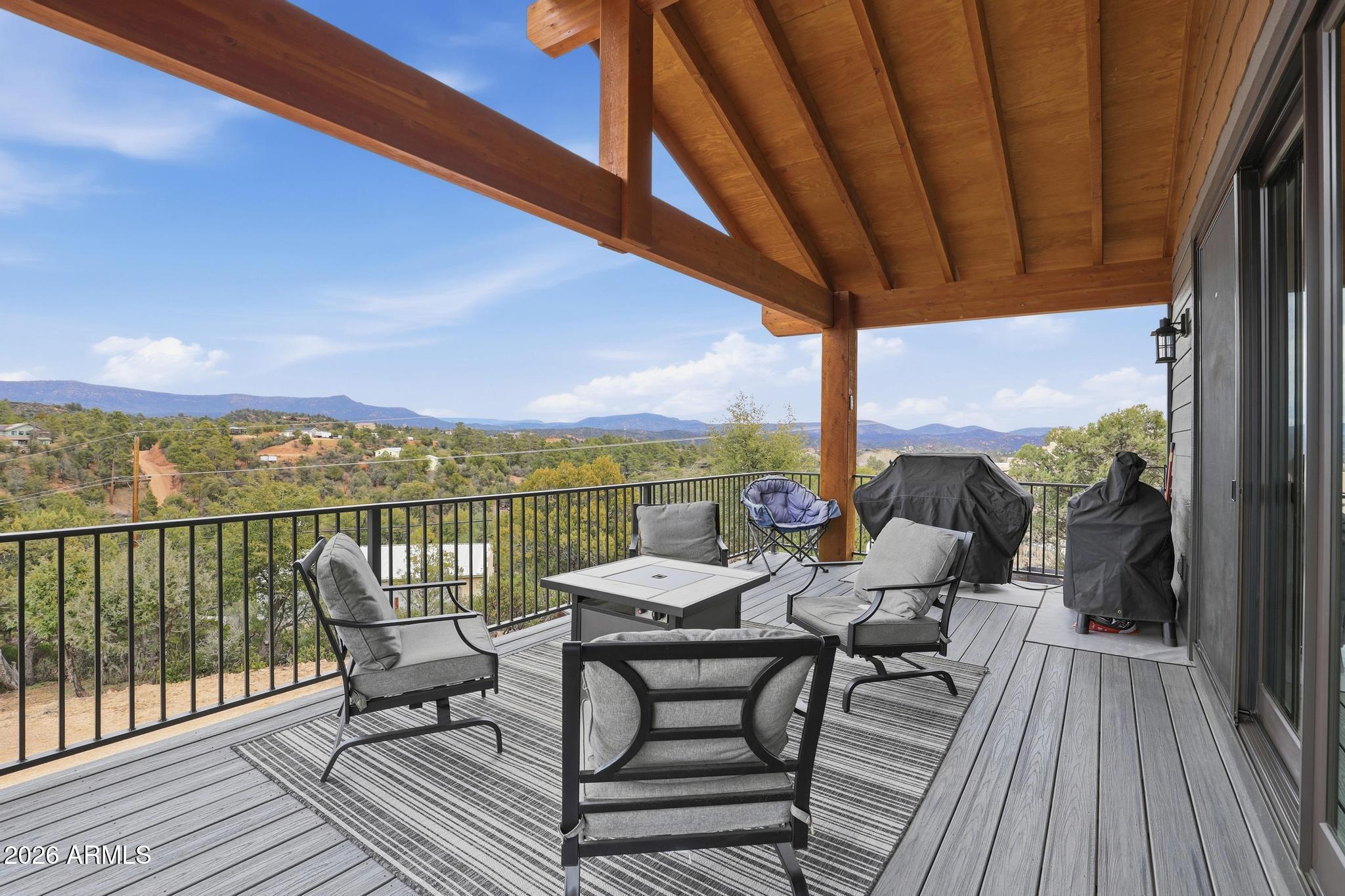 210 Valley Road Payson, AZ 85541 - Photo 20 of 38 a view of a balcony with chairs and wooden floor
