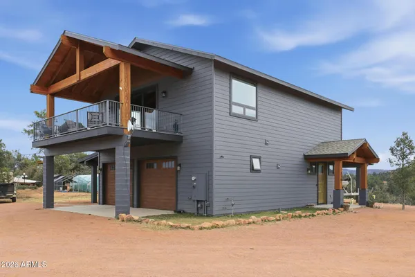 a view of a house with wooden fence