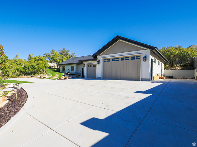 3167 South Mapleton Estates Drive Mapleton, UT 84664 - Photo 32 of 42 View of front of property featuring an attached garage and concrete driveway
