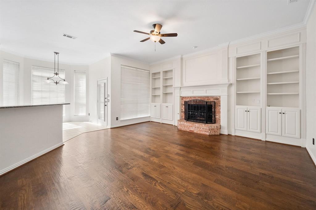 4512 Crown Ridge Drive Plano, TX 75024 - Photo 17 of 32 a view of an empty room with a fireplace and a window