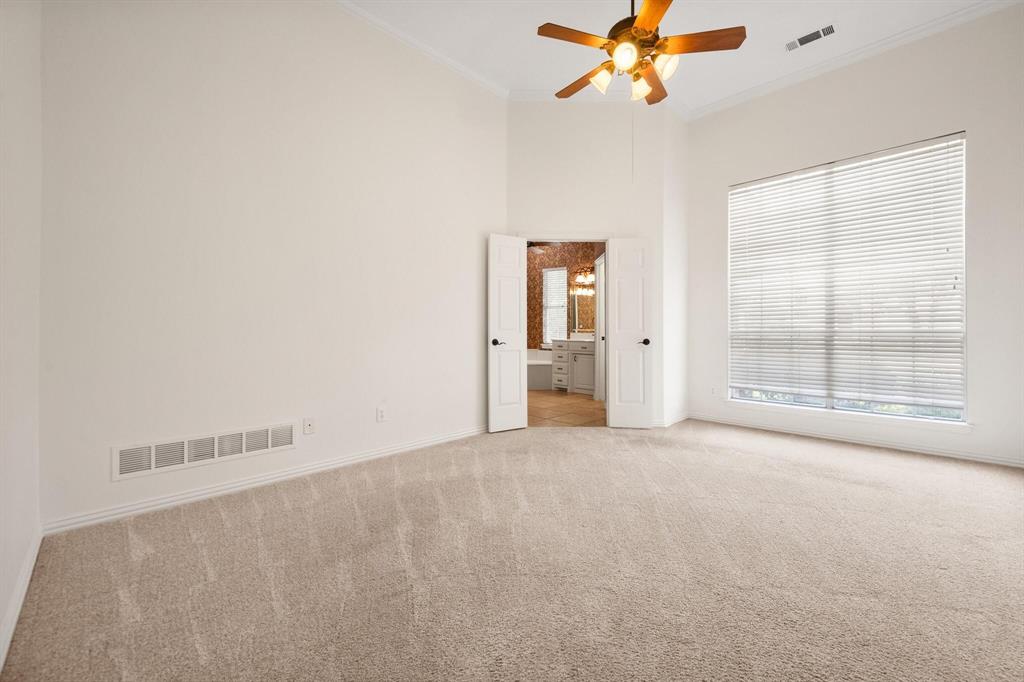 4512 Crown Ridge Drive Plano, TX 75024 - Photo 19 of 32 an empty room with windows and fan