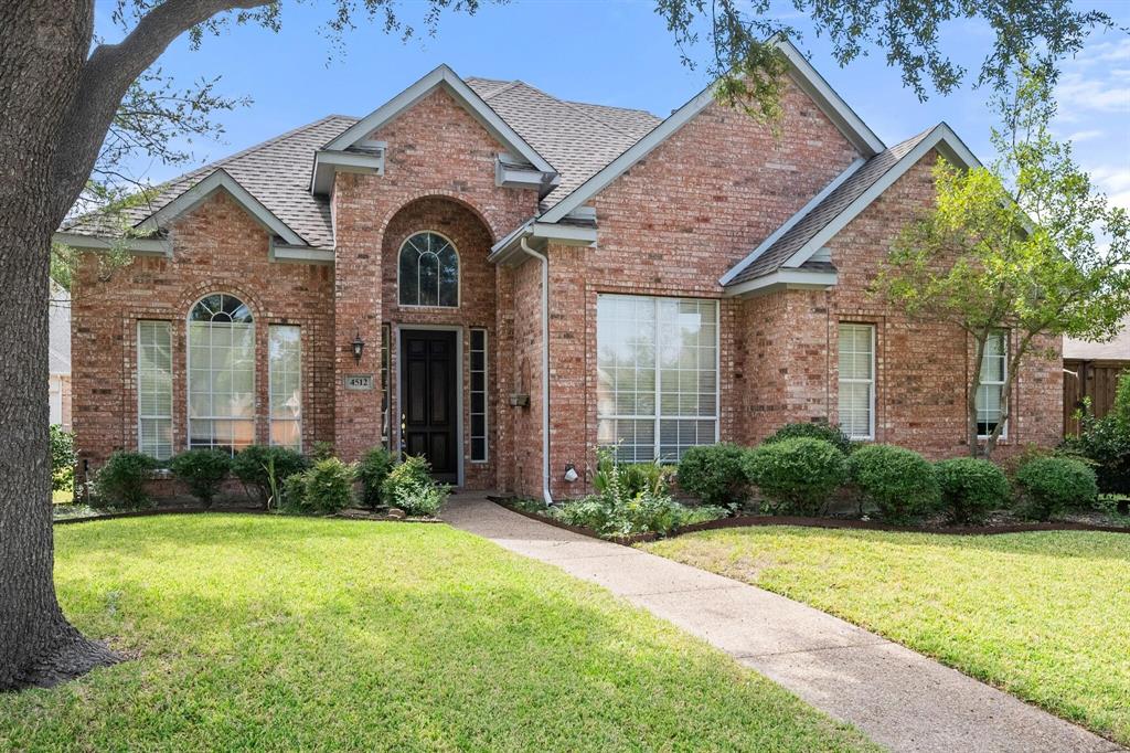 4512 Crown Ridge Drive Plano, TX 75024 - Photo 2 of 32 a front view of a house with garden