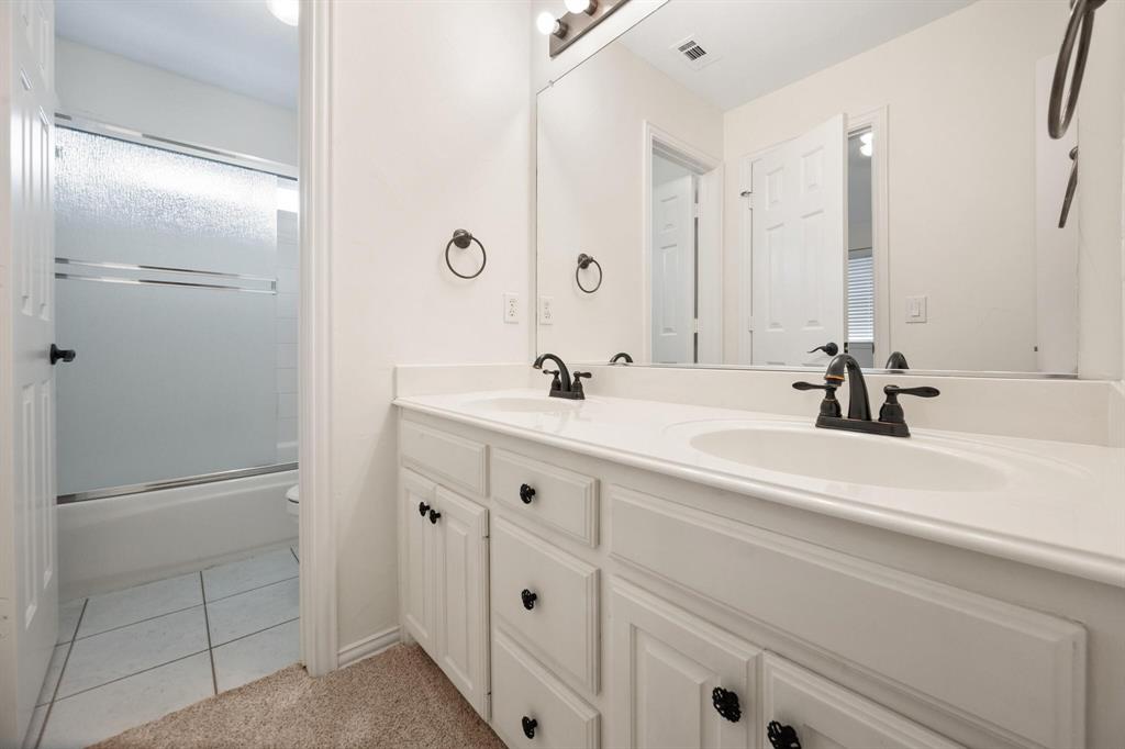 4512 Crown Ridge Drive Plano, TX 75024 - Photo 24 of 32 a bathroom with a sink and a mirror