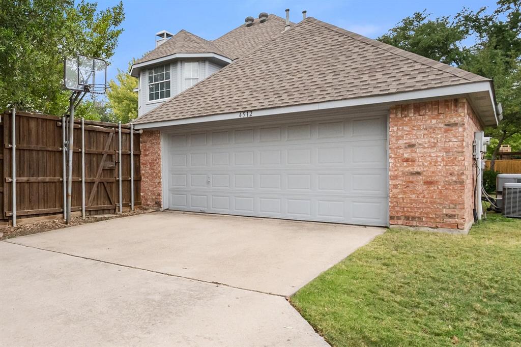 4512 Crown Ridge Drive Plano, TX 75024 - Photo 29 of 32 a front view of a house with a garden