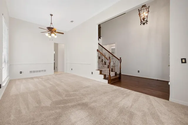 a view of a room with a ceiling fan