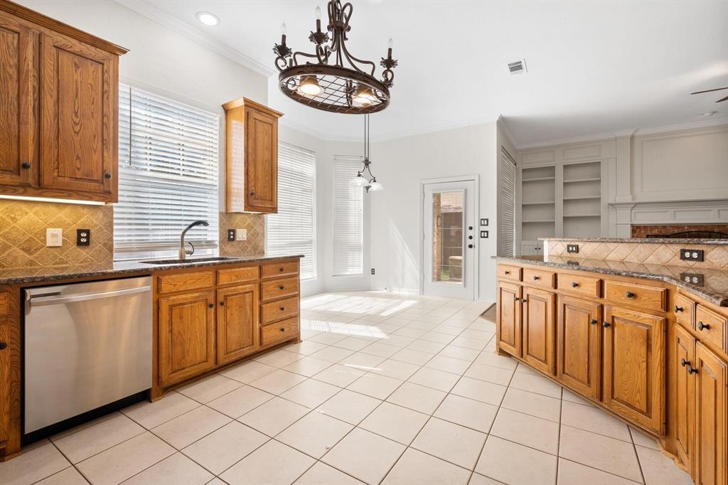 4512 Crown Ridge Drive Plano, TX 75024 - Photo 8 of 32 a kitchen with stainless steel appliances granite countertop a sink and cabinets