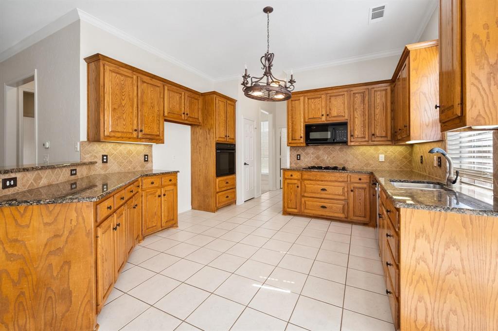 4512 Crown Ridge Drive Plano, TX 75024 - Photo 9 of 32 a large kitchen with stainless steel appliances granite countertop a stove and a refrigerator