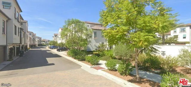 a view of a pathway both side of house