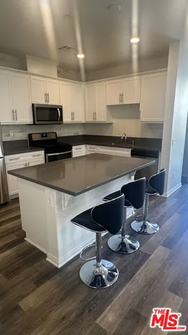 a kitchen with a appliances cabinets and a counter top space