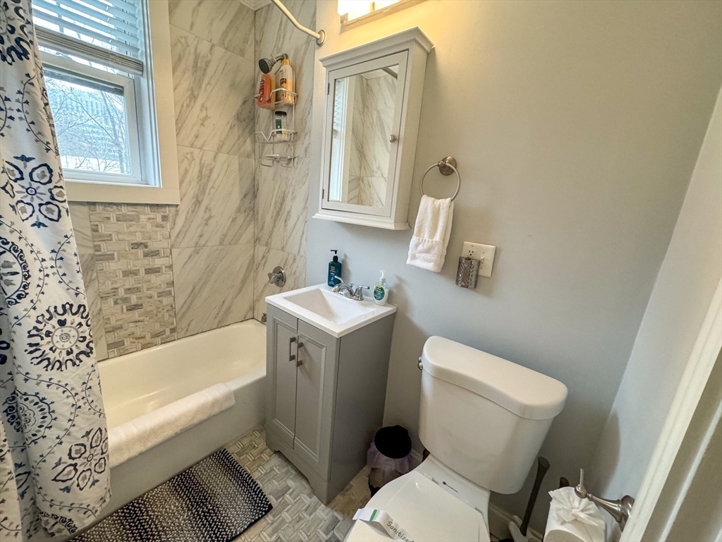 169 Kent Street, Unit 3 Brookline, MA 02446 - Photo 10 of 10 a white bath tub sitting next to a white toilet and sink